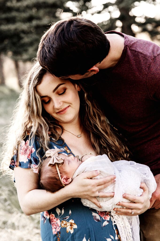 Rapid City, South Dakota family photography, mom and dad with newborn, dad kissing mom